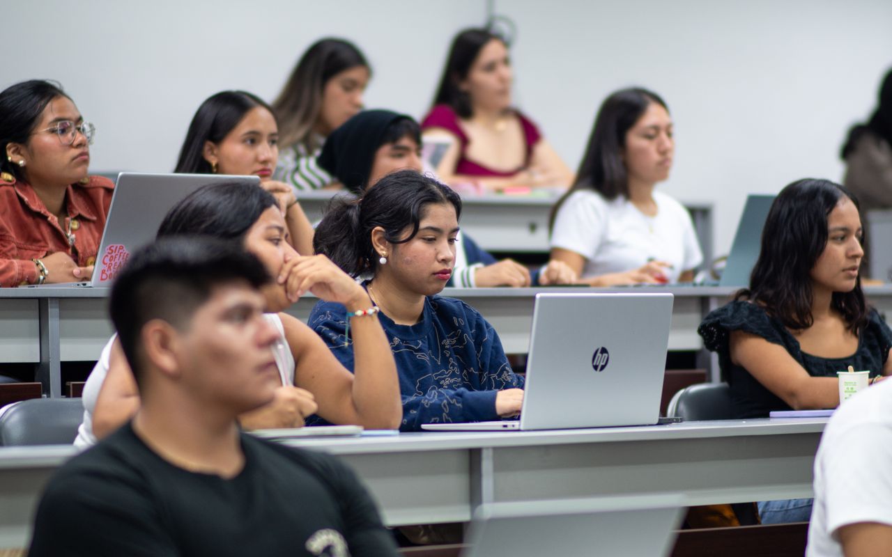 About A diverse group of students attentively listens during a university lecture in Piura, Peru.